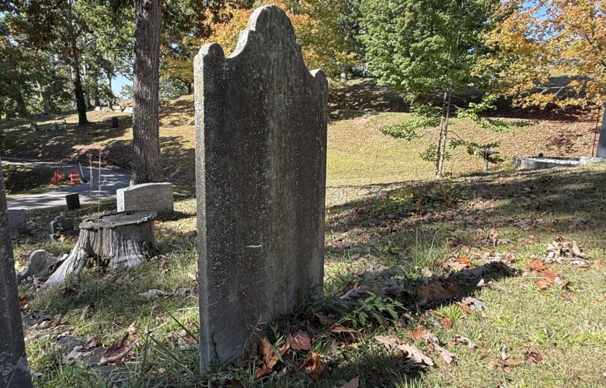 The weathered gravestone of Scottish botanist John Lyon stands at Riverside Cemetery in Asheville. Lyon died in 1814, and historical accounts say his remains were moved twice before reaching Riverside Cemetery.