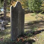 The weathered gravestone of Scottish botanist John Lyon stands at Riverside Cemetery in Asheville. Lyon died in 1814, and historical accounts say his remains were moved twice before reaching Riverside Cemetery.