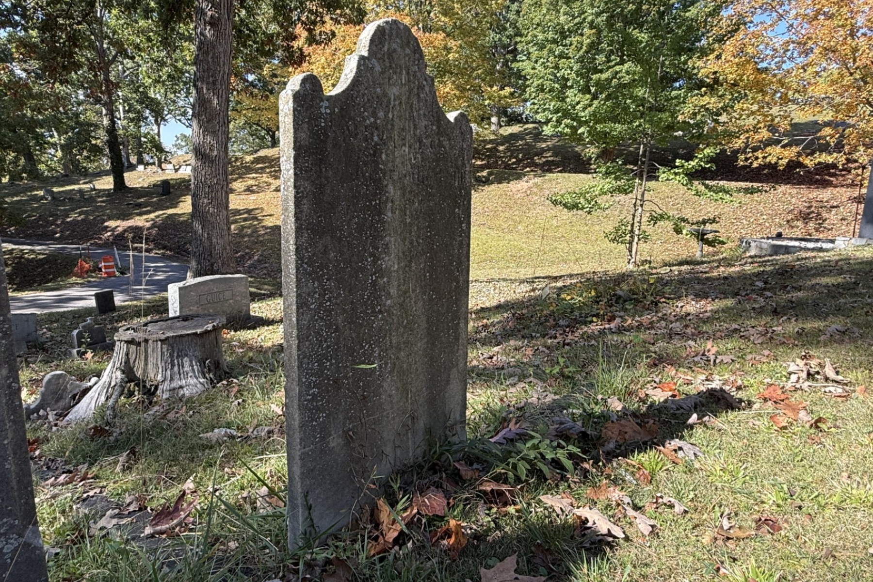 The weathered gravestone of Scottish botanist John Lyon stands at Riverside Cemetery in Asheville. Lyon died in 1814, and historical accounts say his remains were moved twice before reaching Riverside Cemetery.