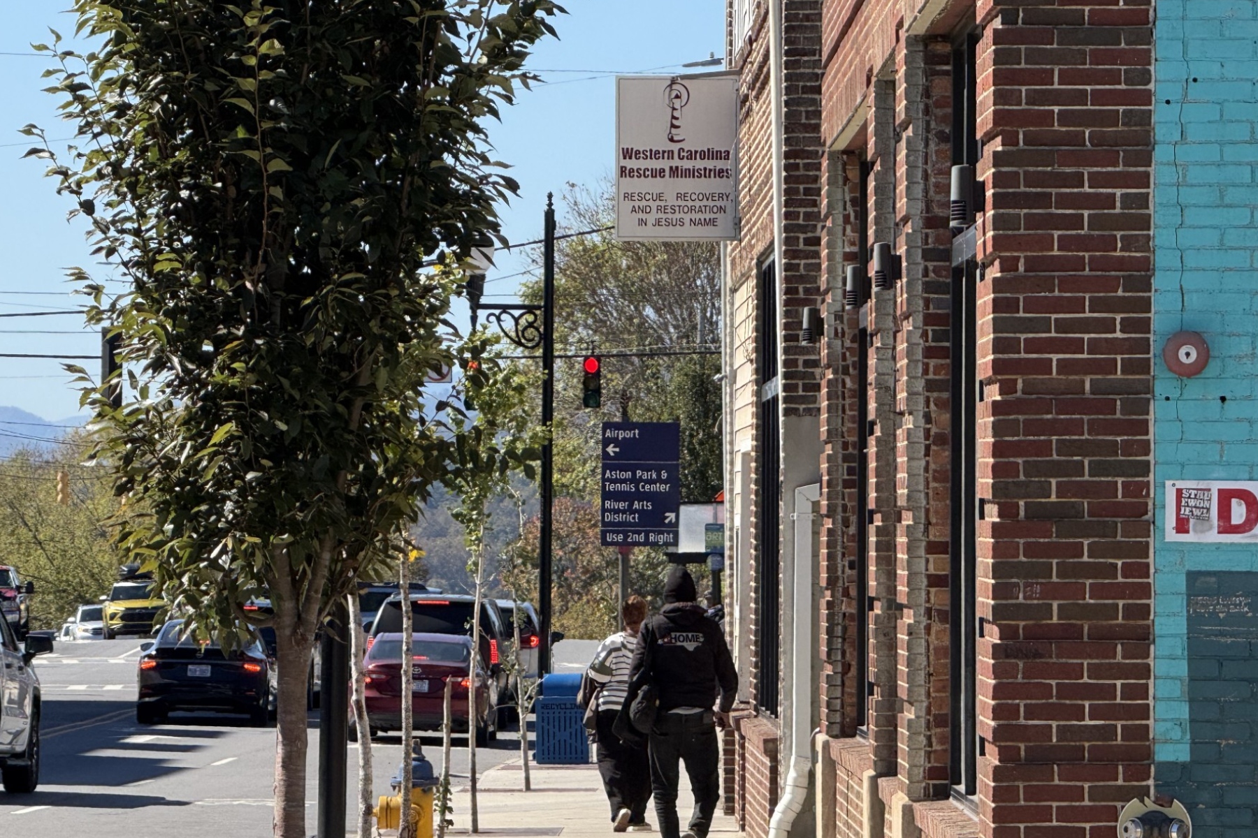 Pedestrians walk past Western Carolina Rescue Ministries in downtown Asheville.
